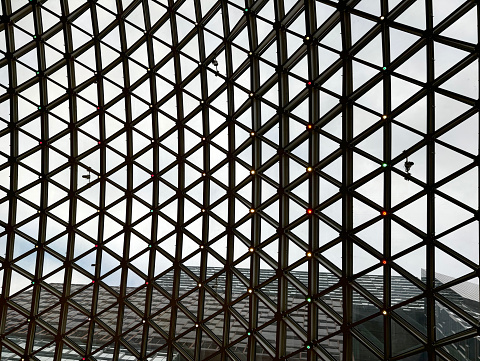 Triangular lattice work of aluminium metal glass frames. Architectural finishes.