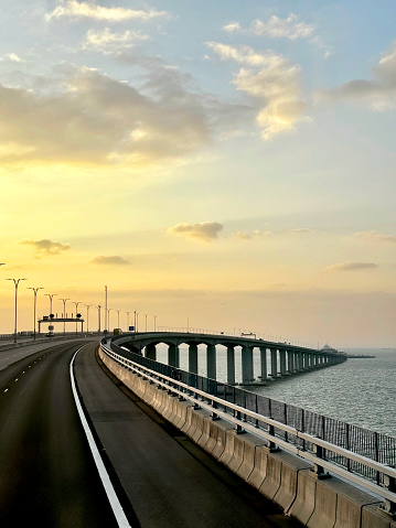 HZMB (Hong kong Zhuhai Macau Bridge) the longest bridge in the world spanning accross 50 km above and under the ocean. Connecting Hong Kong SAR, Macau SAR, and Zhuhai (China). Taken during beautiful sunset.