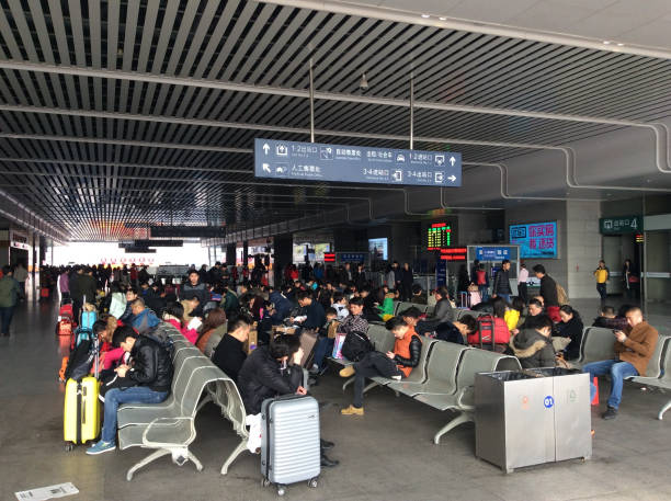 You're looking at a typical day at the railway stations in China. This particular image takes place in Kunshan, which is part of Jiangsu Province. The large crowds of locals wait for their train at Kunshan High-Speed Railway Station.