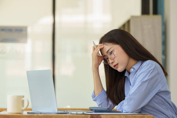 istock Asian businesswoman working on a laptop computer, stressed has a headache, and thinks hard from work at the office. 2124300047