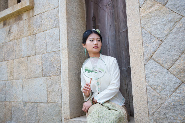 Asian woman sitting on the threshold