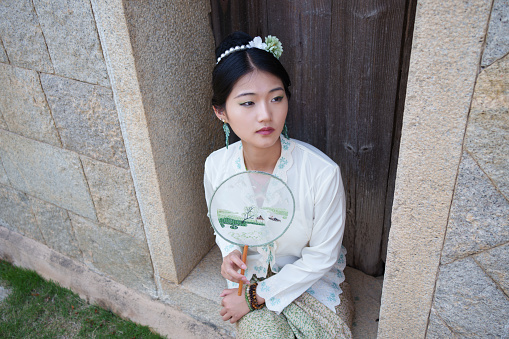 Beautiful woman sitting on the threshold