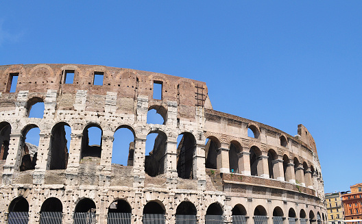 The Colosseum amphitheater  at Rome, early morning with a sunny sky.