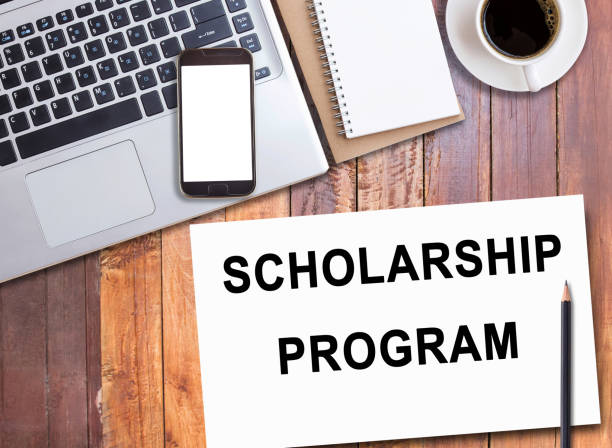 istock Business quotes, SCHOLARSHIP PROGRAM on notebook or paper in office desk, office workplace 2124406348