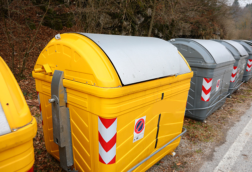 yellow bins in the recycling center of the city ecological oasis for the separate collection of waste