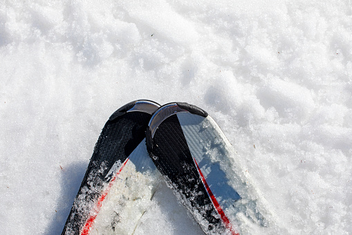 skis on a snowy slope on a sunny day. Active family vacatio
