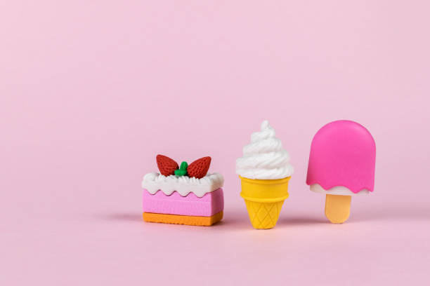 istock Colorful ice cream and cake figurines on a pink background. 2124426639