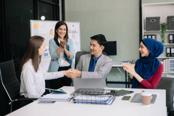istock Business partnership handshake concept.Photo two coworkers handshaking process. 2124476150