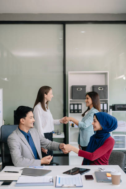 istock Business partnership handshake concept.Photo two coworkers handshaking process. 2124476667