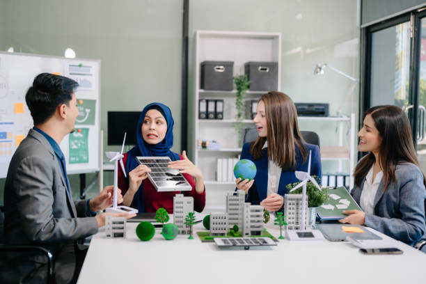 istock Group of alternative energy engineers discussing a project with a worker businesspeople a meeting in solar cell panel and Solar Energy Environment city 2124476697