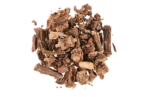 Pile of antamul root (Hemidesmus indicus), also called Indian Sarsaparilla. Close-up, table top view, isolated on white background.