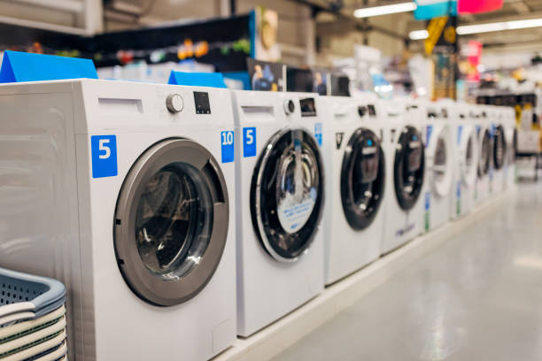 Washing machines lined up next to each other in a department store, in the appliance section