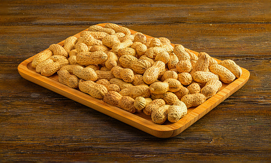 Wooden tray filled with tasty peanuts