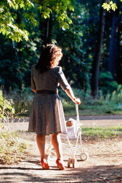 istock Young mother walks her baby in the stroller 2124533711
