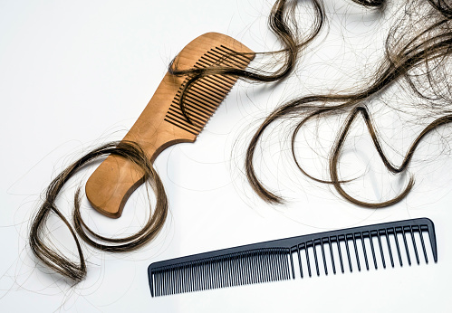 Several combs along with tufts of hair, conceptual image