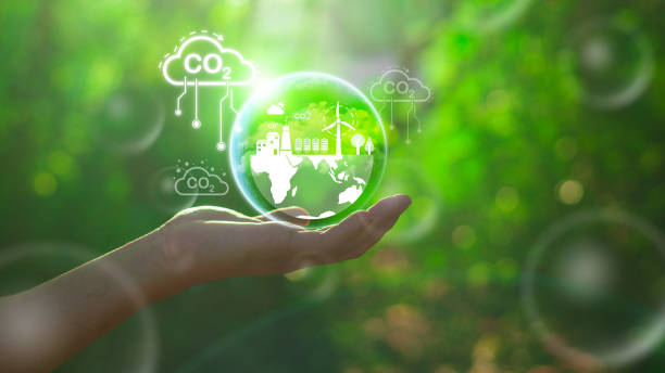 istock Reduce CO2 emission concept in the hand for environmental, global warming, Sustainable development and green business based on renewable energy.CO2 icon on green leaf with water droplet. 2124575199