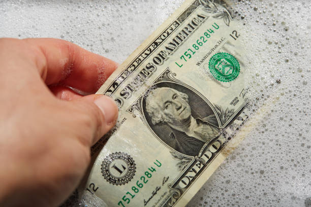 Money laundering. US dollar currency banknotes in soap water