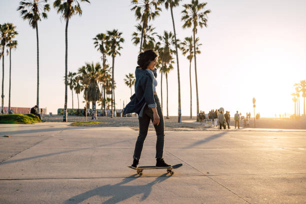 istock Woman skating by the beach at sunset 2124597986