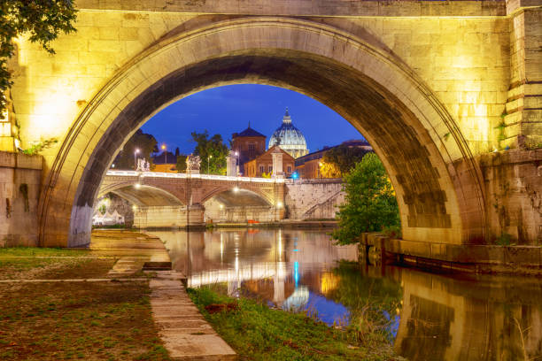 Vatican City - A view across the River Tiber to St. Peter's Cathedral, illuminated after sunset.