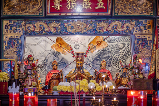 Vihara Gunung Timur Temple, Medan, Sumatra, Indonesia - January 16th 2024: Golden and decorated figures in a hall of Confucius in a Buddhist temple