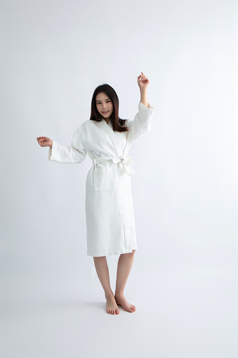 Asian woman in white bathrobe