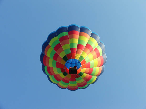 istock colorful hot air balloon soaring against clear blue sky 2124624587