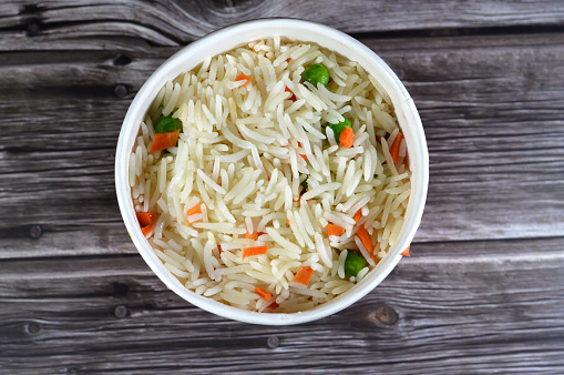 Traditional Chinese food, long grain white Basmati rice with vegetables, carrot and peas, traditional Chinese hot steamed rice usually served with chicken with soy sauce, sweet and sour or chili, selective focus