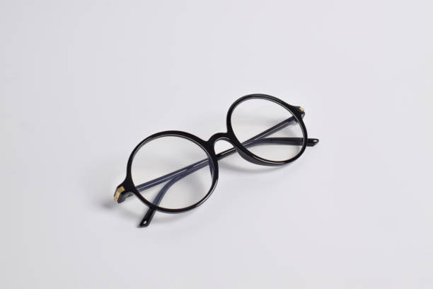 istock Stylish glasses with round black frames on white background 2124649848