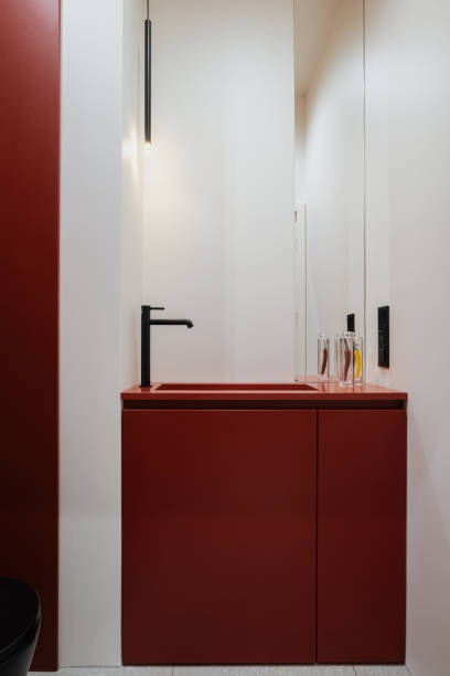 istock a bathroom with a red sink , mirror and toilet 2124660829