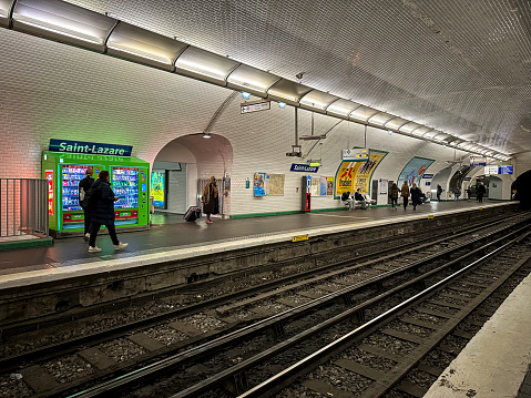Paris, France - 19.02.2024. Saint Lazare metro station platform view. People are waiting for train