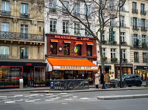 Paris, France - 19.02.2024. Street view of Boulevard Saint-Germain-des-Pres and Brasserie Lipp, a famous historical traditional Parisian brasserie.