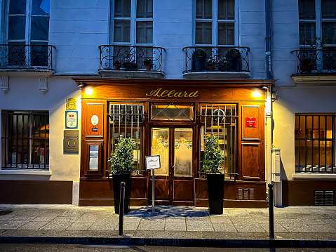 Paris, France - 19.02.2024. Andre Allard French restaurant facade, Old-school bistro offering elevated, traditional French dishes and wines in a warm atmosphere. Restaurant located in Latin Quarter at rue Saint-André-des-Arts