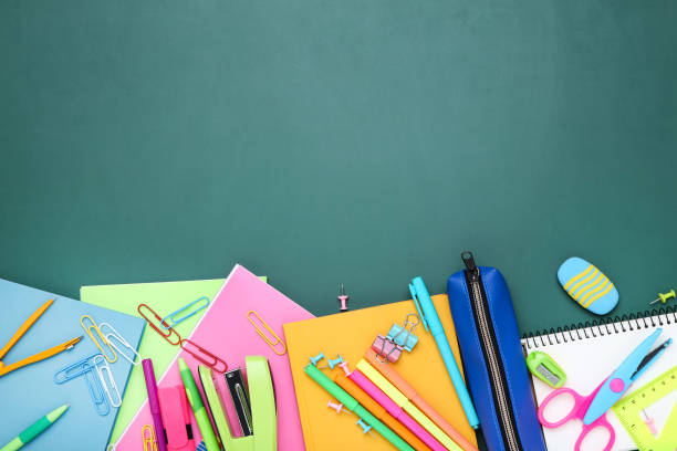 istock Different school supplies on chalkboard background 2124732600