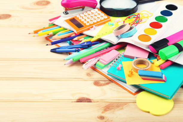 istock School supplies on brown wooden table 2124745606
