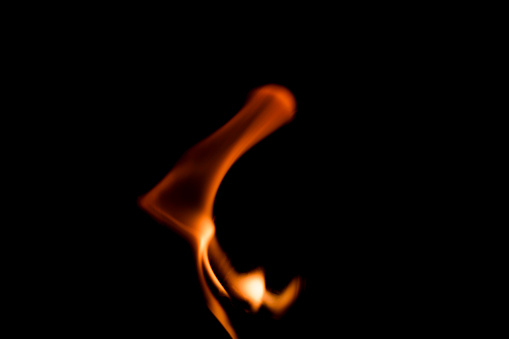 The tiny flames on the black background have an abstract power.