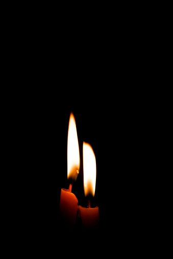 Abstract image of a burning candle flame in the dark.