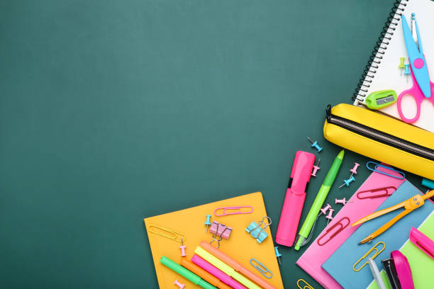 istock Different school supplies on chalkboard background 2124768389
