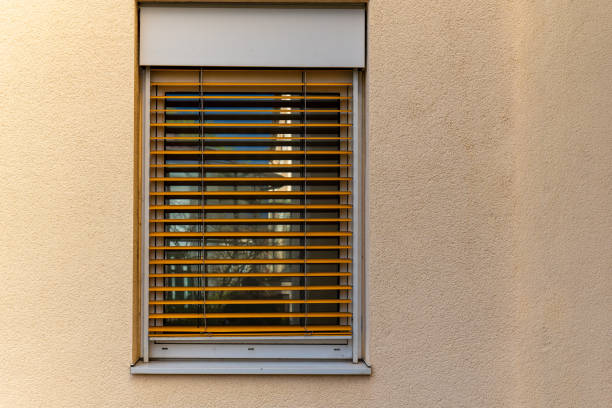 istock window with wooden blinds is shown against a brown wall 2124777596