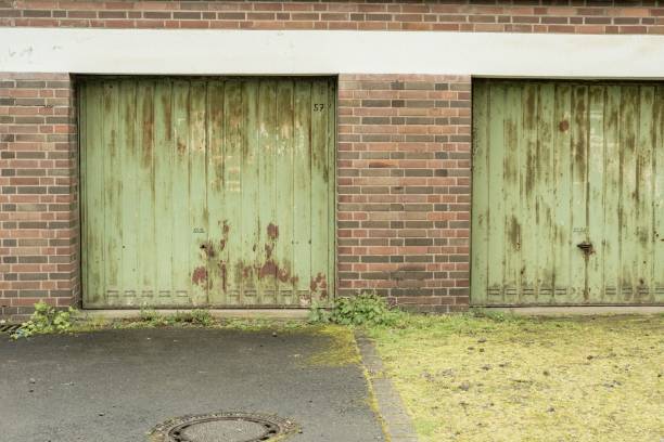 istock rusty green garage doors in the rain 2124780692