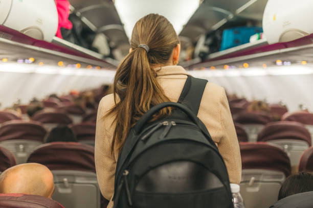 istock Young woman boarding the airplane 2124783165