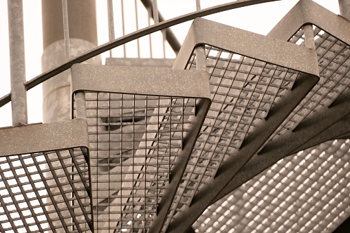 details of a metal spiral staircase in an industrial building