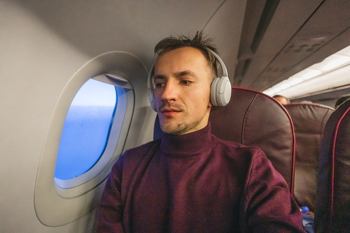 Young man travelling by plane.