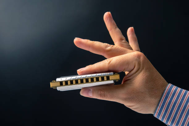 Young woman playing harmonica