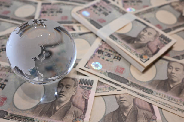 istock 10,000 yen bills and a glass globe 2124863488