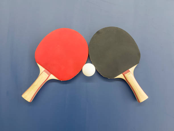 Ping-Pong paddles with ball on table