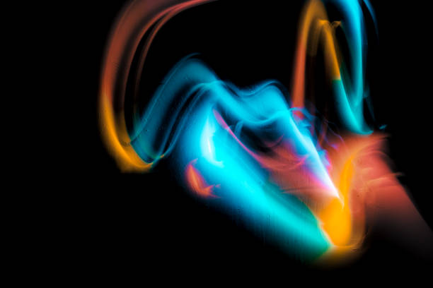 Abstract colorful irregular lines on black background and wall texture. Long exposure. Light painting photography.