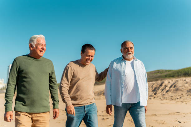 istock Senior friends talking through the beach 2124926433