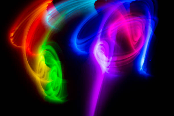 istock Abstract colorful irregular lines on black background and wall texture. Long exposure. Light painting photography. 2124929565