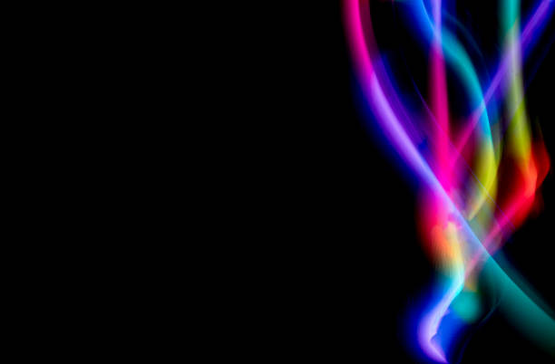 Abstract colorful irregular lines on black background and wall texture. Long exposure. Light painting photography.