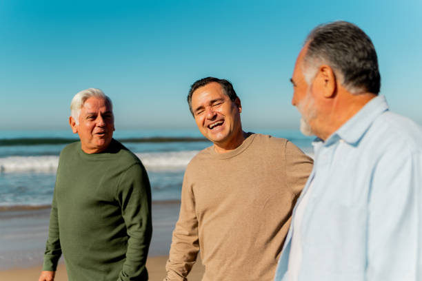Senior friends talking through the beach